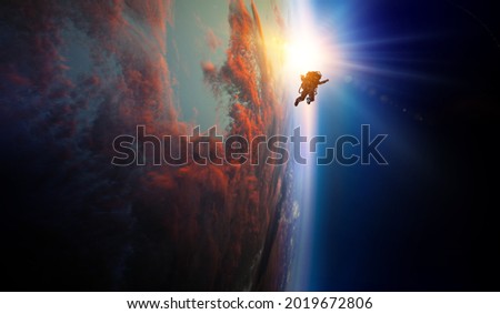 Spaceman and planet, human in space concept . Mixed media Royalty-Free Stock Photo #2019672806