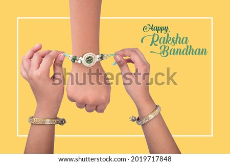 Sister tie Rakhi as symbol of intense love for her brother. Raksha Bandhan Festival Poster Royalty-Free Stock Photo #2019717848
