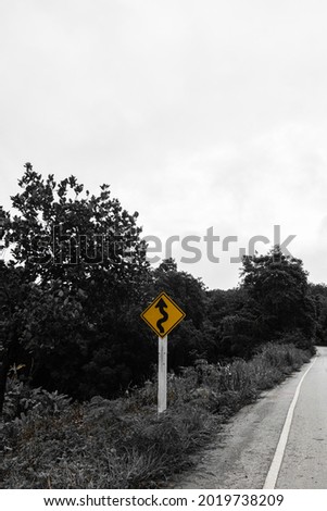 Road Signs curve. Crooked road. Traffic sign on the hill