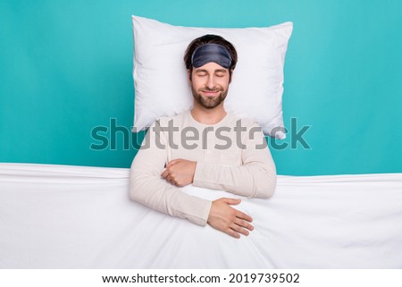 Top above high angle view photo of young man happy positive smile bed sleep cover blanket wear pajama isolated over teal color background Royalty-Free Stock Photo #2019739502