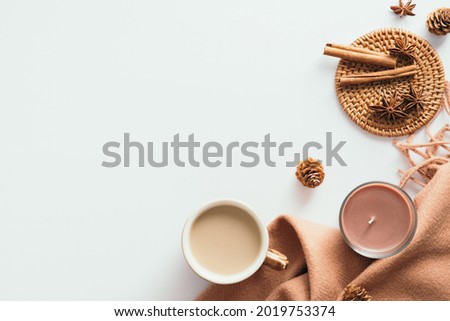 Cozy home desk table with plaid, coffee cup, candle on white background. Top view, flat lay, copy space. Autumn composition. Nordic hygge style concept. Royalty-Free Stock Photo #2019753374