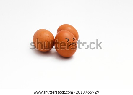 a Group of brown chicken eggs with tired faces isolated on white background.
