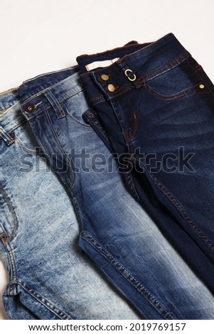 Blue Jeans Pants on white fabric background