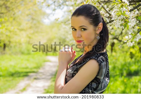  Beautiful brunette woman on spring background