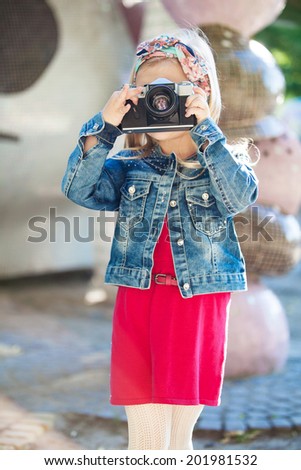 Beautiful smiling girl holding a camera