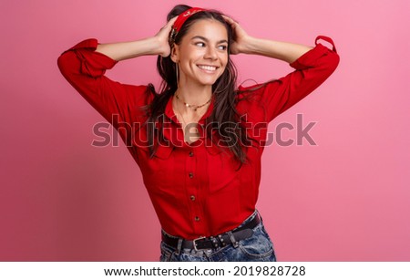 hispanic beautiful woman in red shirt posing smiling on pink studio background isolated wearing headband