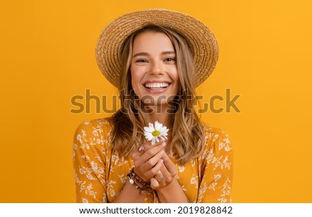 beautiful attractive stylish woman in yellow dress and straw hat holding daisy flower romantic mood posing on yellow background isolated in love summer fashion trend style, natural look Royalty-Free Stock Photo #2019828842