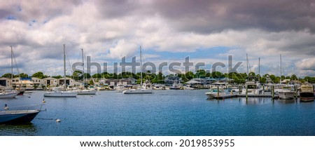 Seascape with mooring boats and yachts and dramatic clouds at Falmouth Marina on Cape Cod.