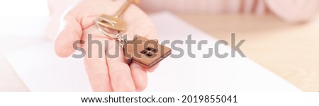 signing a home mortgage agreement, a woman signs a mortgage agreement, a close-up banner