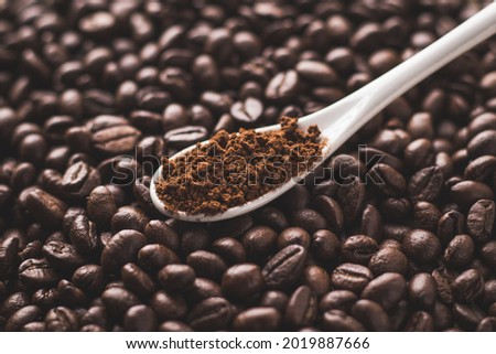 Coffee beans and powder with textured background stock image.
