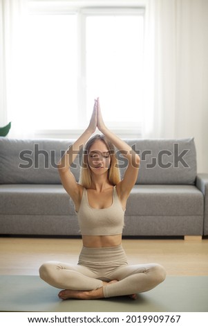 Woman in Meditation on Yoga Mat at Home