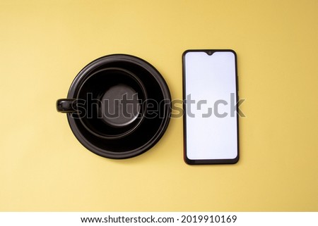 phone and black cup with top view