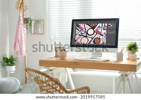 Designer's workplace. Computer with photo editor application on table indoors