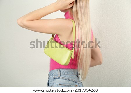 Woman with stylish baguette handbag on white background, closeup