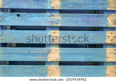 Pale blue painted wooden crate. Close up of wooden pallet 