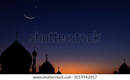 Silhouette mosques dome on dusk sky in the evening and crescent moon for symbol Islamic religion well editing text on free space celebration Ramadan Kareem, Eid Mubarak, Eid Al Fitr, Eid Al Adha 