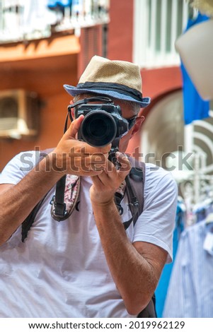 Photographer in Amalfi taking pictures of beautiful town, Italy