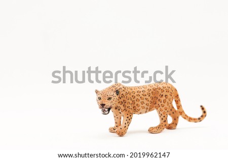 Realistic plastic wild cat toy isolated on a white background. Cute little animal toy for kids. Copy space