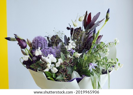 A bouquet of spring blue, yellow flowers in flower shop delivery. Postcard, selective focus side view