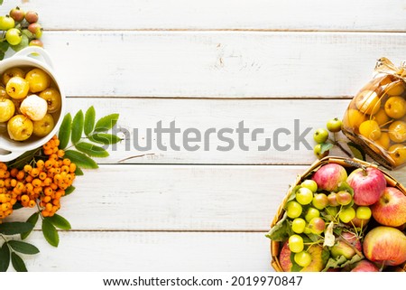 Autumn background.. Paradise apples in sugar syrup on a white wooden table. Harvesting the autumn harvest. Paradise apple jam. Top view. Copy space. Royalty-Free Stock Photo #2019970847