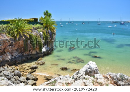 Praia da Rainha beach in Cascais town, Portugal. Summer beach with turquoise water. Royalty-Free Stock Photo #2019972428