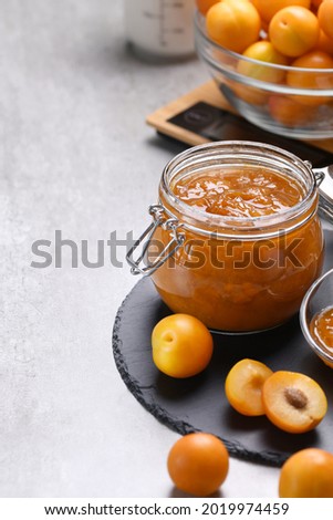 Delicious and aromatic seedless plum jam for the winter can be prepared and preserved at home. The result is a delicious dietary vegetarian product. Close-up on a gray background, copy space. 