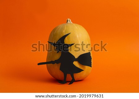 halloween pumpkin and paper witch on orange background halloween holiday, invitation