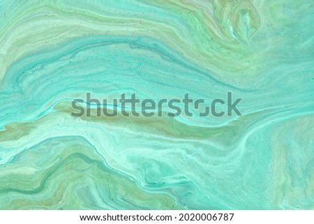Abstract fluid art background light turquoise and cyan colors. Liquid marble. Acrylic painting with cerulean gradient and splash. Watercolor backdrop with wavy pattern. Stone marbled section.