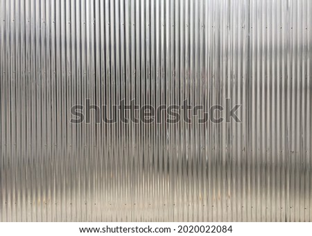 wall or fence made of galvanized steel sheet has a small wavy appearance