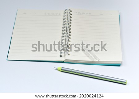 notepad with pen white background