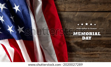 Happy Memorial Day concept. Top view flag of the United States of America and inscription with congratulations over wooden background.