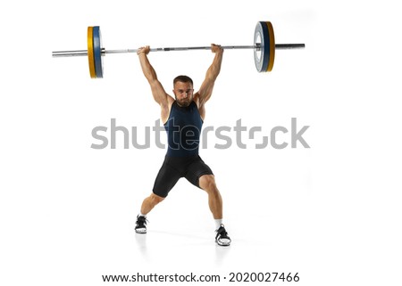 Full length portrait of man in sportswear exercising with a weight isolated on white background. Fit young muscular caucasian model with barbell training at abstract gym. Sport, weightlifting concept Royalty-Free Stock Photo #2020027466
