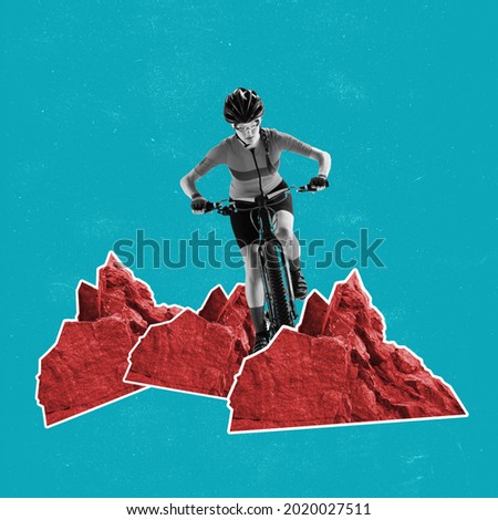 Young female cyclist riding on bicycle among red mountains. on deep green background. Surrealism, minimalism in artwork. Inspiration, creativity and sports concept