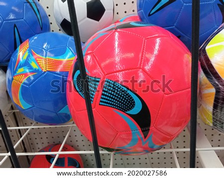 single rubber pink soccer ball on basket in shelf for stock photo or illustration, sports equipment