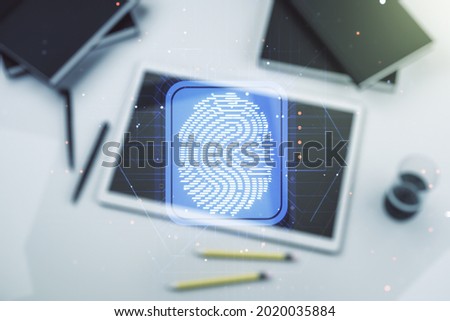 Abstract creative fingerprint illustration and modern digital tablet on desktop on background, top view, personal biometric data concept. Multiexposure