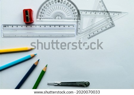 Geometric Measuring tools, Drawing items and mathematical instruments placed on white paper sheet. Back to school and Engineering education learning background. Empty Copy space room for text.