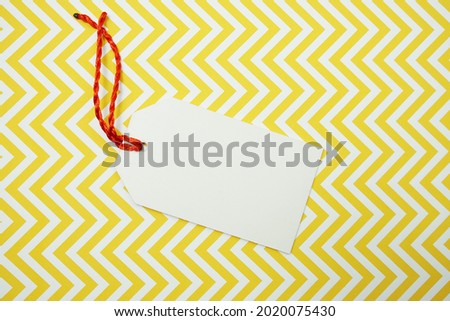 Flat lay White Blank Tag on yellow background