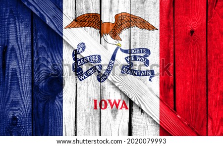 State of Iowa flag is depicted on a wooden background close-up