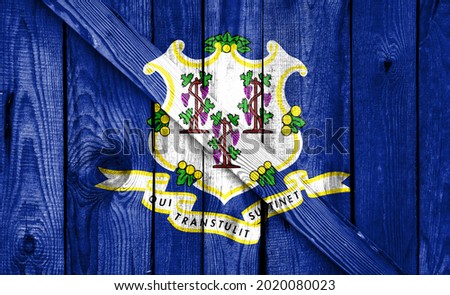 State of Connecticut flag is depicted on a wooden background close-up