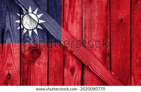 Taiwan flag is depicted on a wooden background close-up