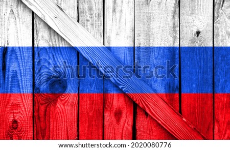 Russia flag is depicted on a wooden background close-up