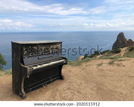 lonely old piano on the background of the sea shore