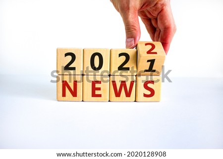 2022 News new year symbol. Businessman turns a wooden cube and changes words 'News 2021' to 'News 2022'. Beautiful white background, copy space. Business, 2022 News new year concept.