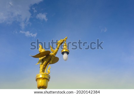 Golden swan lamp on electricity, on blue sky background, in Thailand