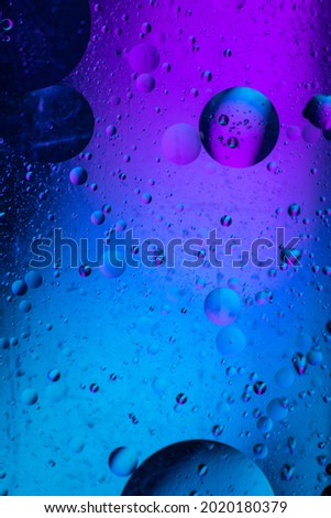 Abstract background similar to drops of water, the result of mixing water and oil. Full color. Abstract colorful circles wallpaper. Macro photograpy.