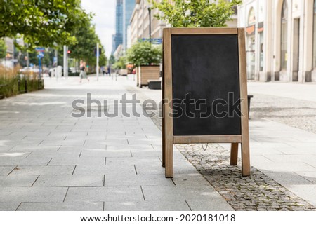 Empty sandwich chalkboard stand on a street ready to be filled