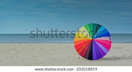 Color pattern of an umbrella with the sky as background.