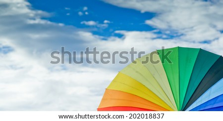 Color pattern of an umbrella with the sky as background.