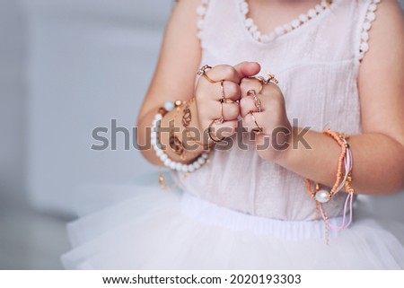 bijou jewelry rings on little baby girl hands Royalty-Free Stock Photo #2020193303