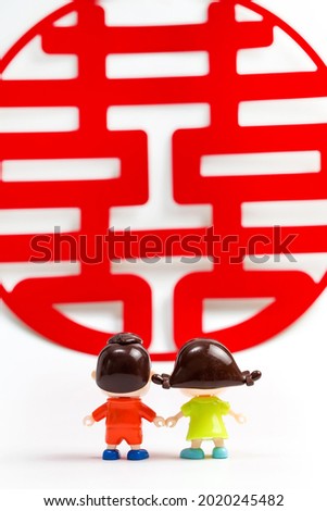 Two dolls and the Chinese character "Xi" in red